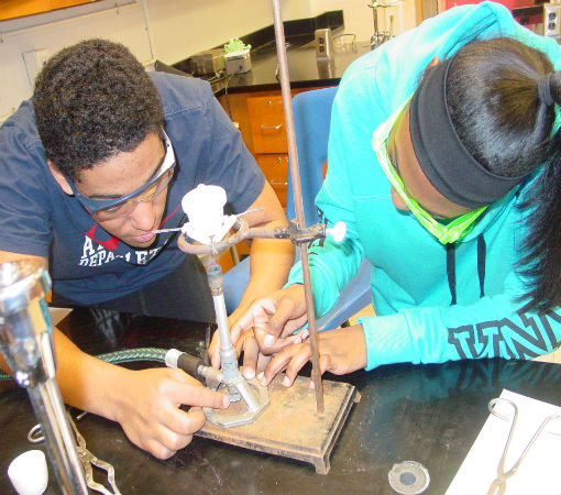 Courtland P. and Lauren W. work with the bunsen burner